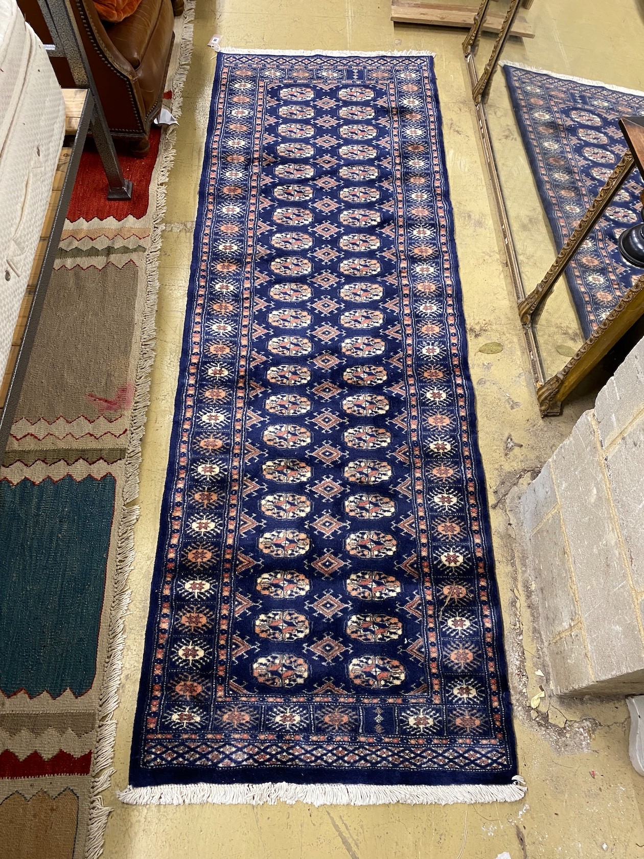A Bokhara style blue ground runner, 230 x 76cm